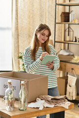 Young woman organizing clothes for donation in a cozy and bright living space