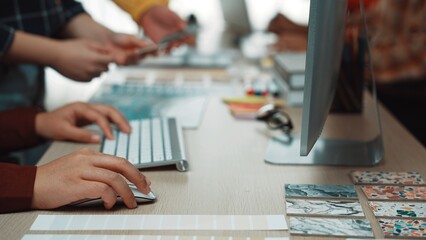 A dynamic scene showcasing diverse hands engaged in design work at a modern workspace, highlighting collaboration with digital tools, colorful swatches, and creative inspiration. SACTR