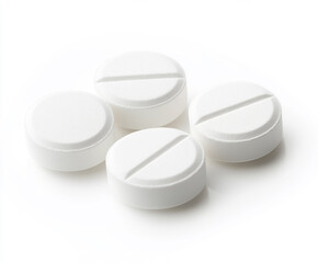 Four white round generic medical tablets with score line on white background