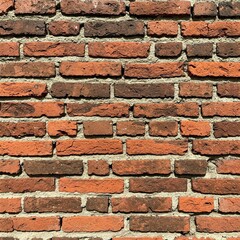 Obraz premium A weathered brick wall, showcasing a rich tapestry of red and brown hues, with varying shades and textures.