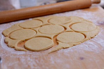 Cutting dough circles for homemade pastries
