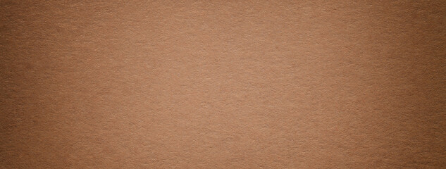 Texture of brown vintage paper gradient background with dark vignette. Structure of craft umber...