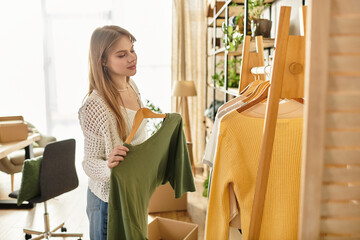 Young woman embracing a sustainable lifestyle by sorting and donating clothes