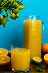 Close-up of cut oranges on a table. Orange juice in a glass