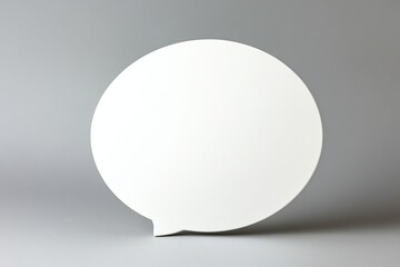 Speech bubble on a pastel grey background for creative communication ideas
