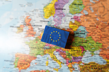 Wooden blocks painted with the European Union EU flag placed on a Europe map, symbolizing European unity, integration, politics, and economy