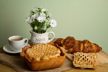 Homemade pastries. Sweet pastries at home. Croissants, waffles on the table