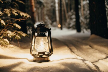 A lantern glowing warmly in the snow