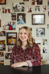 Young Blonde Woman sitting at a desk and smiling