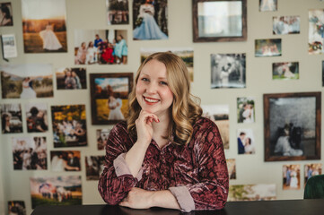Young Blonde Woman sitting at a desk and smiling