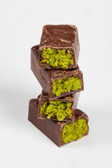 Dubai chocolate. Chocolate with crispy kataifi dough filling and emerald pistachio paste. White background