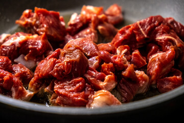 Fresh and Raw Beef Chunks Perfectly Prepared and Ready for Cooking in a Pan for Meals