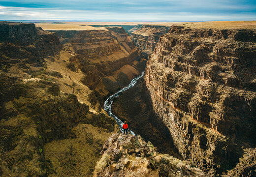 Majestic Bruneau Canyon Overlook with River and Lone Hiker from the above, Idaho, USA. Drone photo
