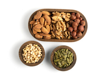 Mixed nuts in wooden bowls isolated on white background. Top view.