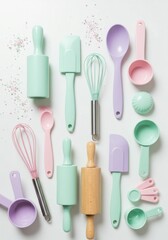 A collection of pastel baking utensils and delicious baked goods on a white backdrop.