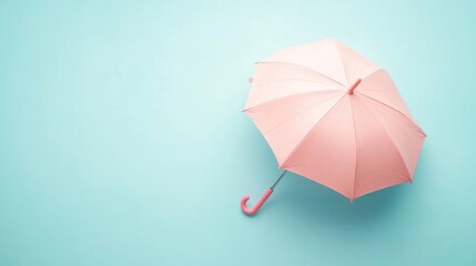 Pastel pink umbrella on a light blue background