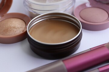 Set of decorative cosmetics and makeup brushes on a white background, eye shadow, blush, powder, bronzer, makeup brushes