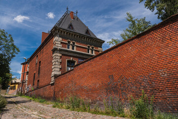 Brick wall and building in the city of Bydgoszcz in Poland