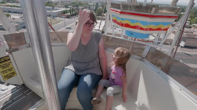 Mother and Daughter Riding a Ferris Wheel at the State Fair in ABQ, NM