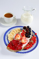 Delicious Breakfast with Toast, Berries, and Chocolate Cookies on a Light Background