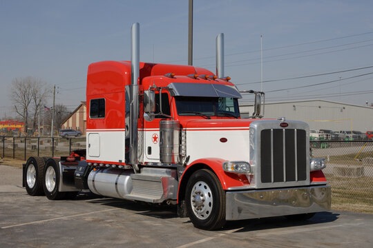 Peterbilt Semi Tractor Trailer Trucks Lined up for sale. Peterbilt is owned by PACCAR Trucks.