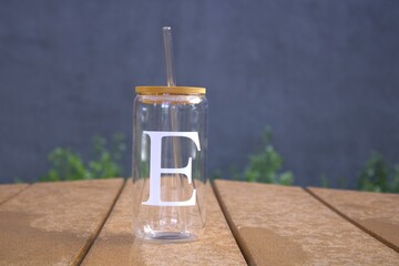 glass cup and straw with wood lid and letter E design
