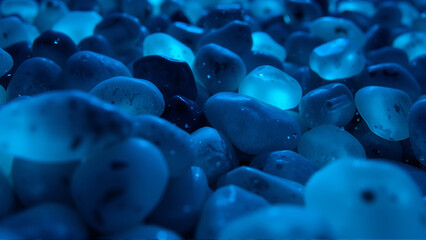 Obraz premium Blue stones glow underwater at night