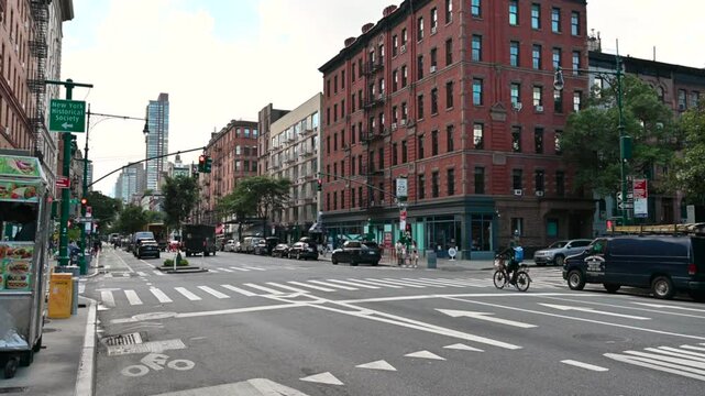 New York,USA,August 19, 2024. Street view on Columbus. Near us vintage red brick buildings and further away the skyscrapers of Manhattan. Passing cars and people on the sidewalks. Travel destinations.