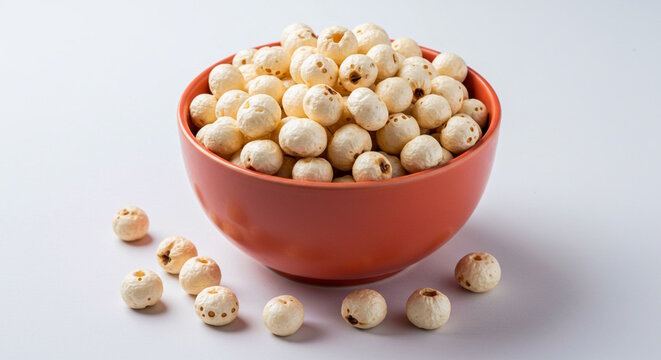  Fox nut also known in india as Dried makhana, phool makhana, lotus or water lily seeds in bowl, used in India for preparing various foods cooking, sweets, healthy snack, white background