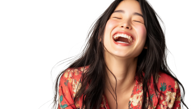 Joyful woman laughing while wearing a floral dress against a light background in a bright and cheerful atmosphere