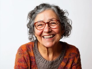 Fototapeta premium Portrait of a happy older woman wearing glasses and smiling directly at the camera