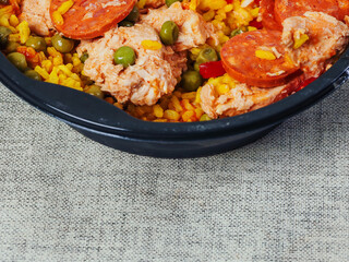 Spanish paella dish with spicy chorizo sausages. Close up. Popular traditional food made of fine rice and other ingredients.