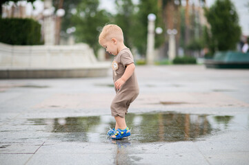 Toddler Playing in a Rain Puddle Outdoors