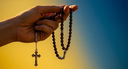 Hand holding a rosary against the sky for prayer, meditation, and Catholic faith-related content