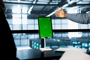 Engineers using isolated screen tablet in data center, managing server virtualization. Workers using mockup device in server room, sustaining long term infrastructure reliability