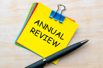 Top view of Annual Review text on yellow notepad