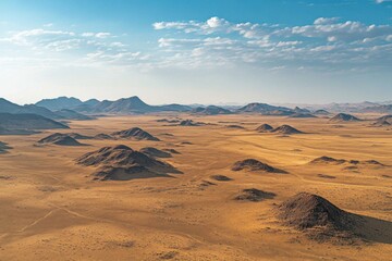 Naklejka premium Aerial view of arid desert landscape with mountains