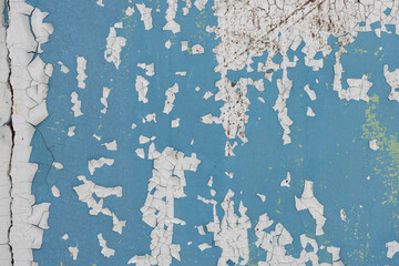 Peeling paint on the wall. Old concrete wall with cracked flaking paint. Weathered rough painted...