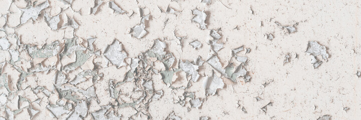 Peeling paint on the wall. Old concrete wall with cracked flaking paint. Weathered rough painted...