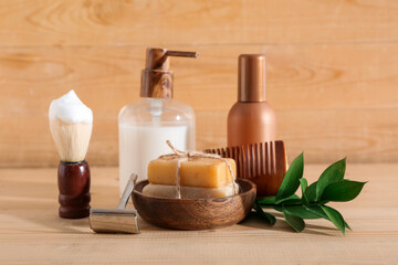 Set of shaving accessories on wooden background