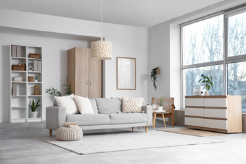 Interior of stylish living room with grey sofa and big window
