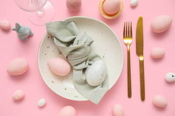 Beautiful table setting with Easter eggs on pink background