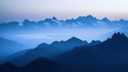 Obraz premium Misty mountain range at dawn. Vast, serene, and majestic peaks shrouded in a light blue haze