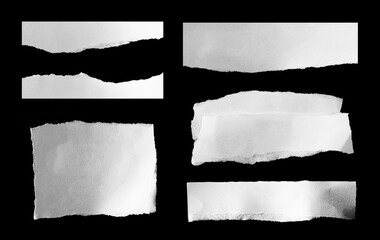 Collection of torn ripped paper on black background.
