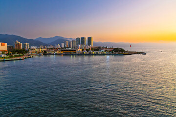 Obraz premium Evening sunset view of the Puerto Vallarta coastline and skyline at Golden Hour from the cruise port at Puerto Vallarta, Mexico.