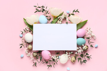 Composition with blank card, flowers, green twigs and Easter eggs on pink background