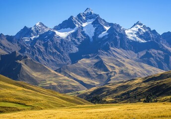 Obraz premium Majestic Snow-Capped Peaks Surrounded by Golden Grassy Hills and Clear Blue Sky in the Andes Mountains Region