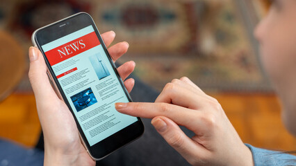 woman reading newspaper on smart phone