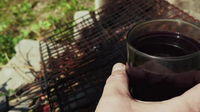 Burning Wood Fire Barbecue and a Glass of Wine