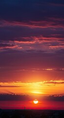 Fototapeta premium Breathtaking orange and purple sunset with dramatic clouds over calm ocean horizon